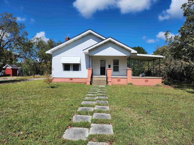 view of front of property featuring a front lawn and covered porch