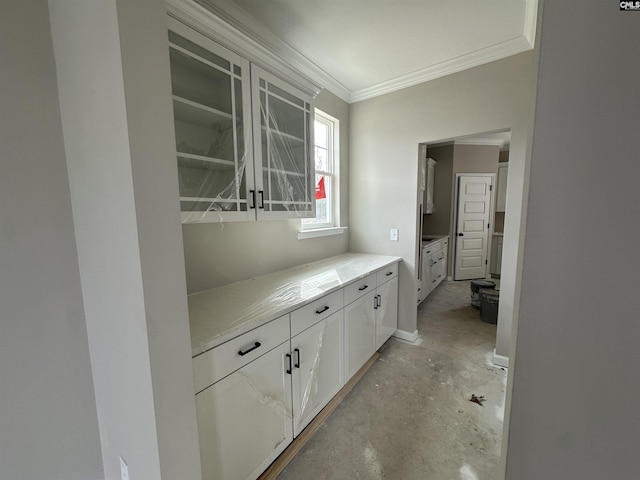 hall with ornamental molding and unfinished concrete flooring