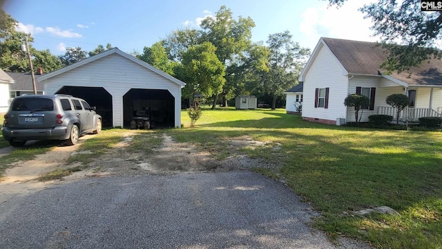 exterior space featuring a storage shed and a garage