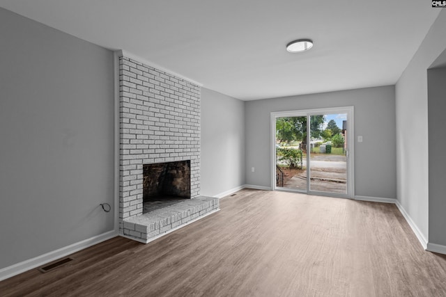 unfurnished living room featuring hardwood / wood-style flooring and a fireplace