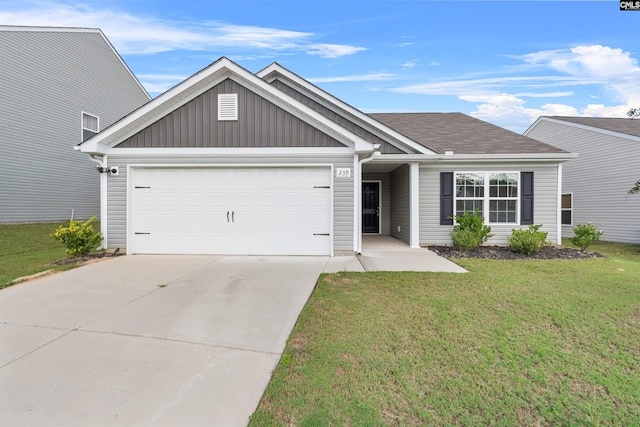 view of front of property featuring a front yard and a garage