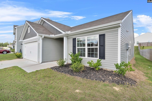 view of front of home featuring a garage and a front lawn