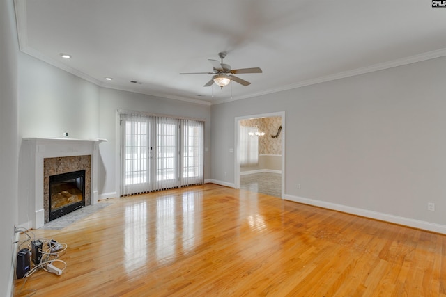 unfurnished living room featuring ornamental molding, a tile fireplace, and light hardwood / wood-style floors