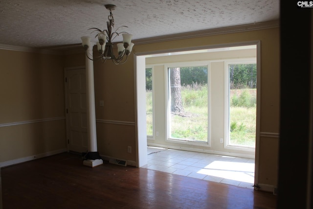 unfurnished dining area featuring wood-type flooring, crown molding, and a healthy amount of sunlight