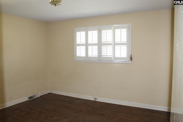 unfurnished room with dark hardwood / wood-style floors