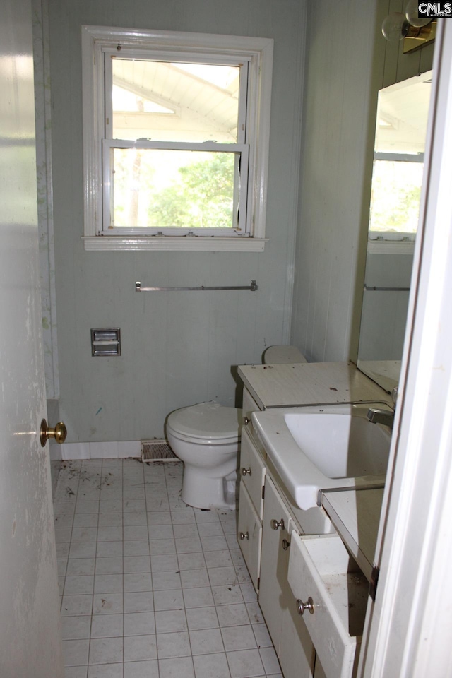 bathroom featuring tile patterned flooring, vanity, and toilet