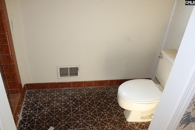 bathroom featuring tile patterned flooring and toilet