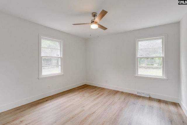 empty room with light wood-type flooring, ceiling fan, and plenty of natural light