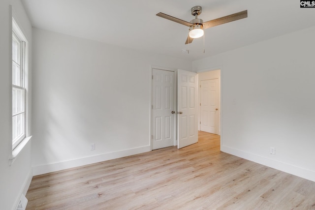 unfurnished room with light wood-type flooring and ceiling fan