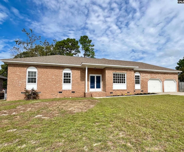 single story home with a front yard and a garage