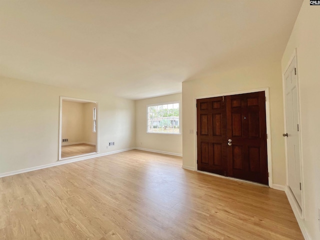 unfurnished room with light wood-type flooring