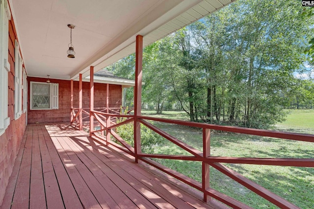 wooden deck with a lawn