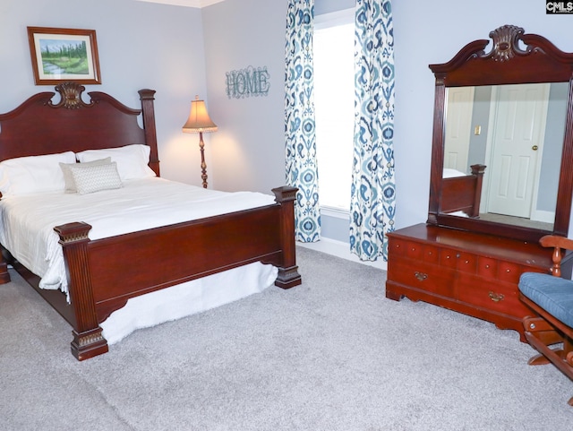 bedroom featuring light colored carpet