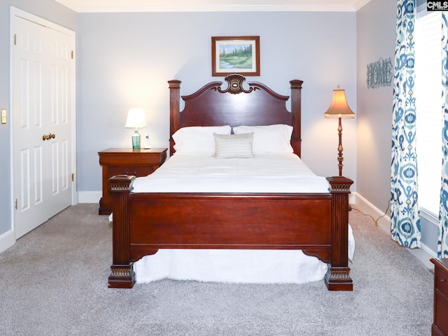 carpeted bedroom featuring crown molding