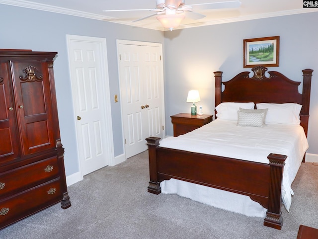 carpeted bedroom featuring ornamental molding and ceiling fan