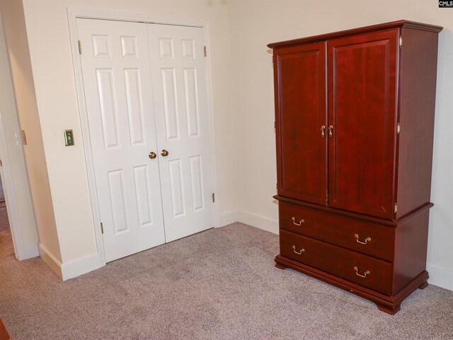 unfurnished bedroom featuring light colored carpet