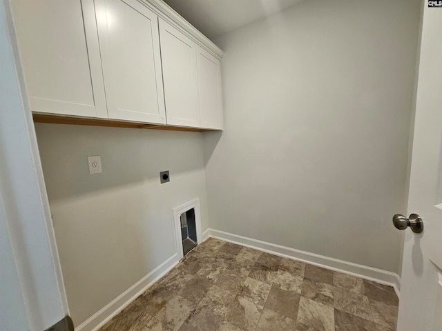 washroom featuring electric dryer hookup and cabinets