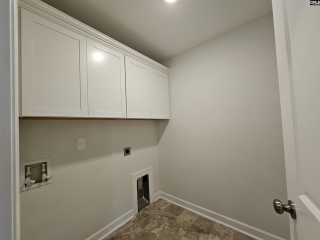 clothes washing area featuring electric dryer hookup, hookup for a washing machine, and cabinets