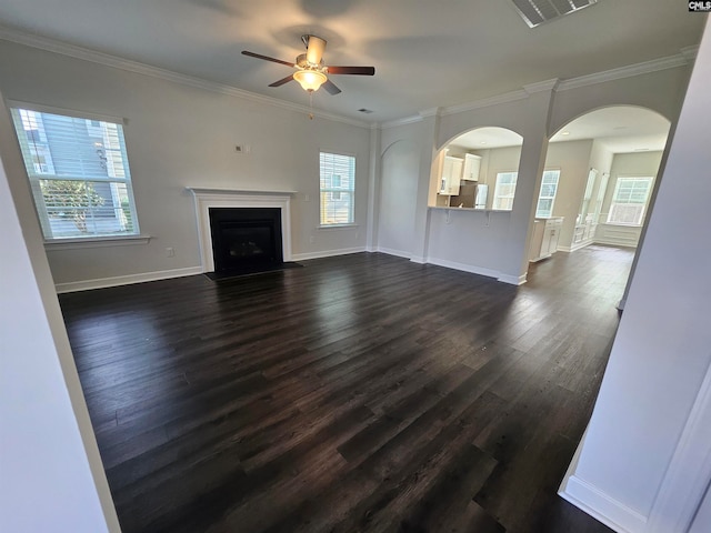 unfurnished living room with dark hardwood / wood-style flooring, ceiling fan, and ornamental molding