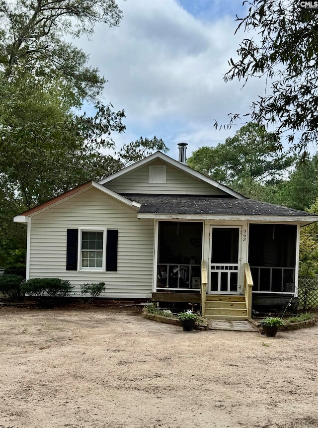 view of front of house featuring a sunroom