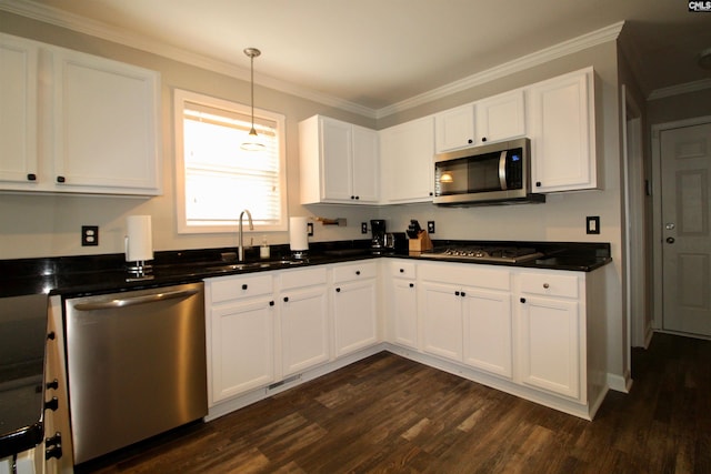 kitchen featuring stainless steel appliances, a sink, dark wood-style floors, white cabinets, and dark countertops