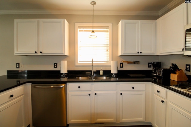 kitchen with appliances with stainless steel finishes, a sink, white cabinetry, dark countertops, and crown molding