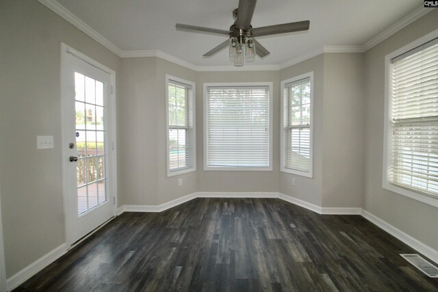 unfurnished room with healthy amount of natural light, dark wood-style floors, ceiling fan, and crown molding