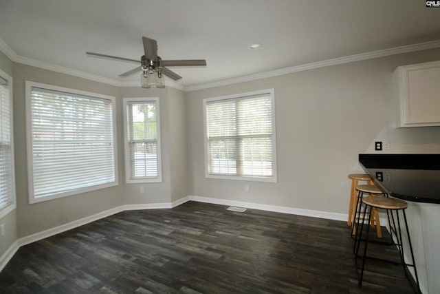 unfurnished dining area with ornamental molding, dark hardwood / wood-style flooring, and ceiling fan