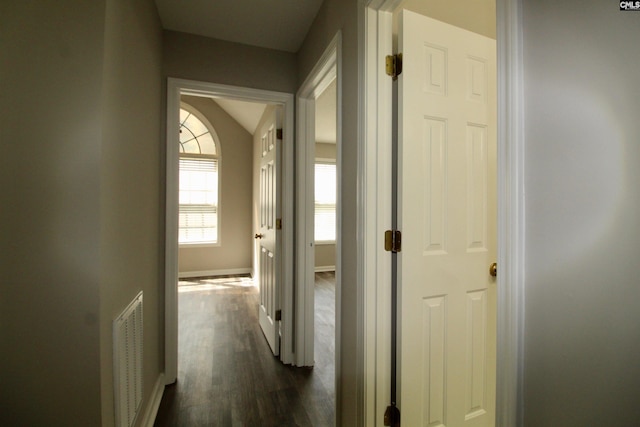 hall with dark hardwood / wood-style floors and vaulted ceiling