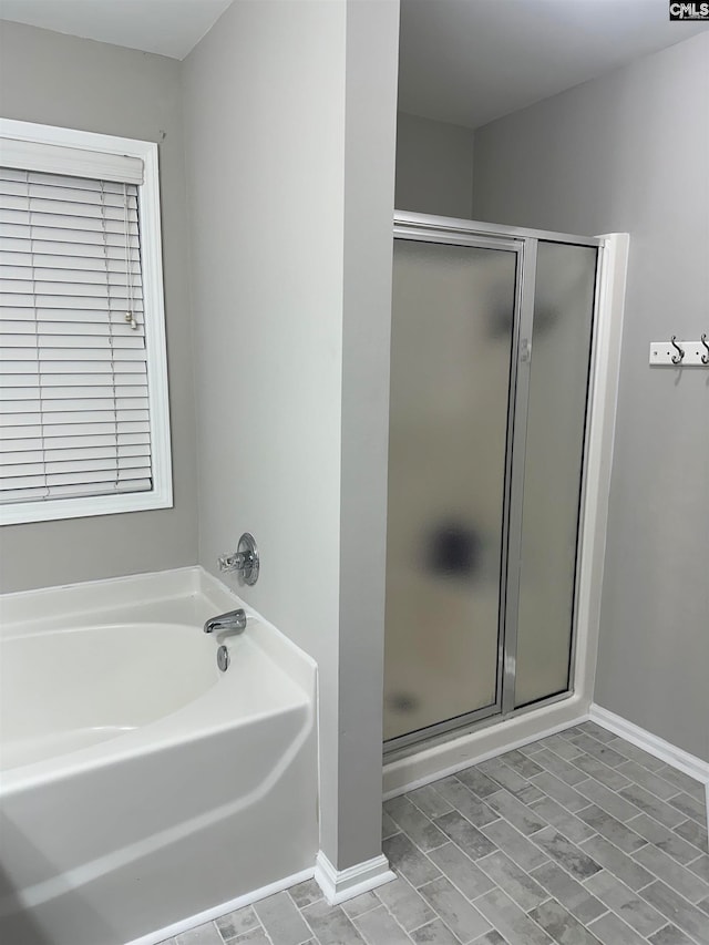 bathroom with shower with separate bathtub and wood-type flooring