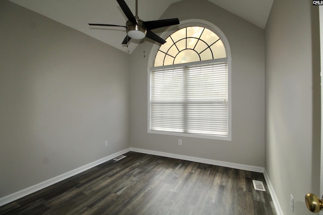 empty room with lofted ceiling, ceiling fan, and dark wood-type flooring