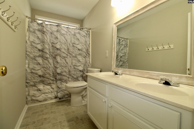 bathroom featuring vanity, toilet, and a shower with shower curtain