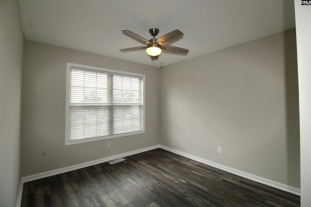 spare room featuring ceiling fan and dark wood-type flooring