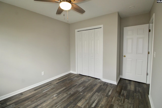 unfurnished bedroom with dark hardwood / wood-style flooring, ceiling fan, and a closet