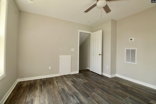 unfurnished room with dark hardwood / wood-style floors and ceiling fan