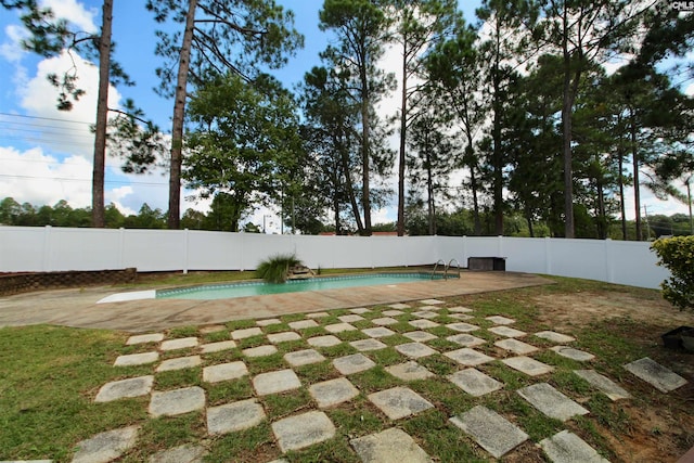 exterior space with a fenced in pool and a patio area