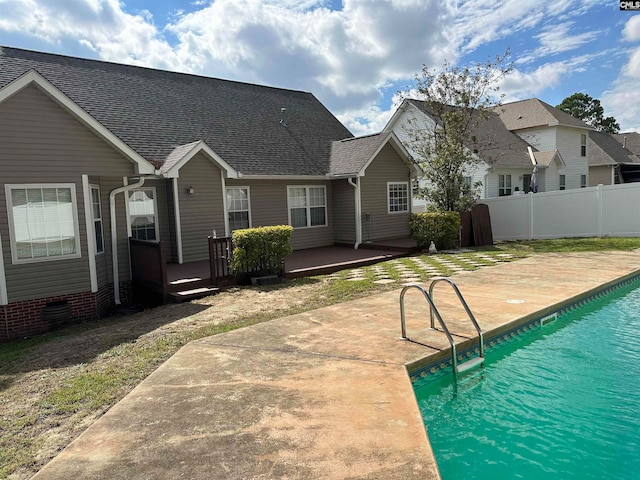 view of pool featuring a wooden deck and a patio