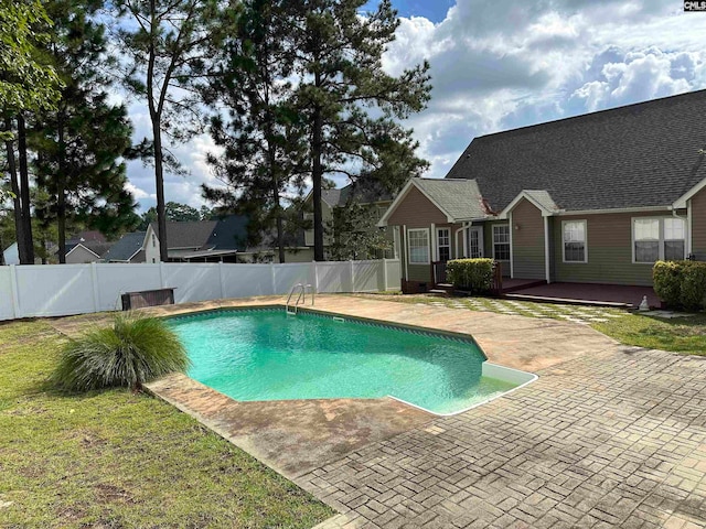 view of swimming pool featuring a lawn and a patio area