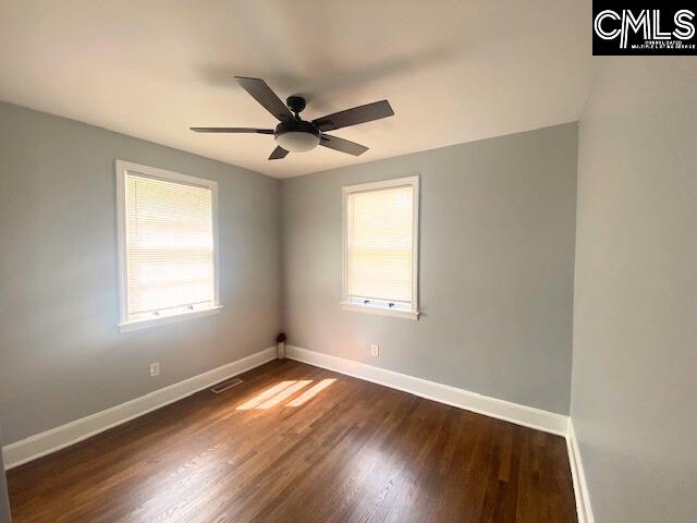 spare room featuring ceiling fan and dark hardwood / wood-style flooring