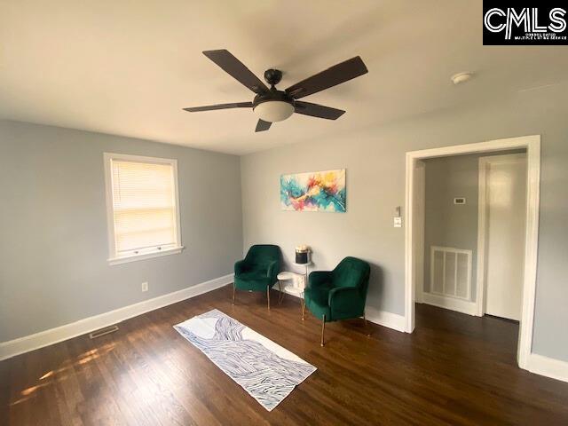 unfurnished room featuring ceiling fan and dark wood-type flooring