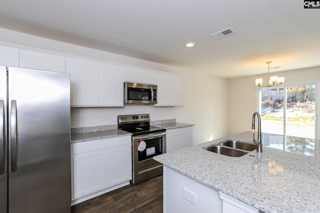 kitchen with sink, decorative light fixtures, white cabinetry, stainless steel appliances, and dark hardwood / wood-style flooring