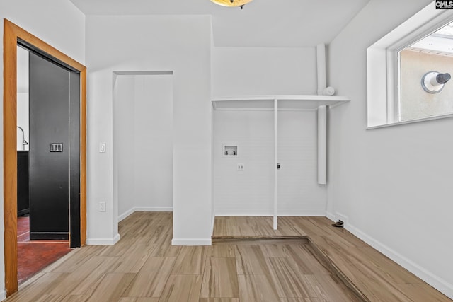 laundry room with light hardwood / wood-style floors and hookup for a washing machine