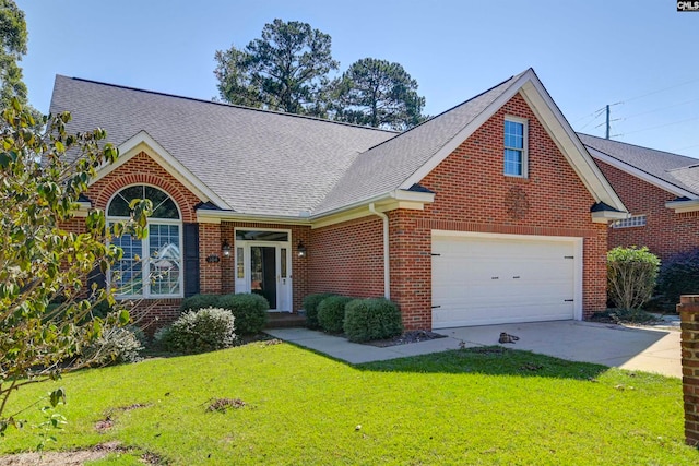 view of front of house with a garage and a front lawn