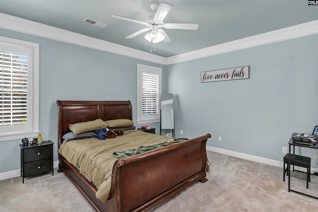 bedroom with ceiling fan, light carpet, and crown molding