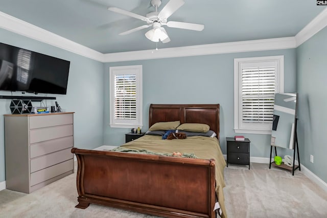 bedroom with multiple windows, crown molding, ceiling fan, and light colored carpet