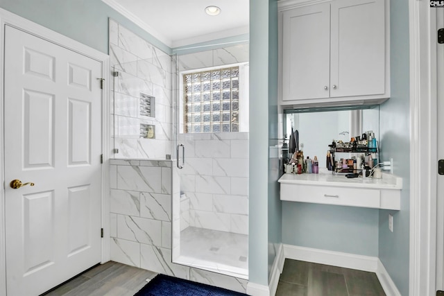 bathroom with ornamental molding, a shower with door, and hardwood / wood-style floors