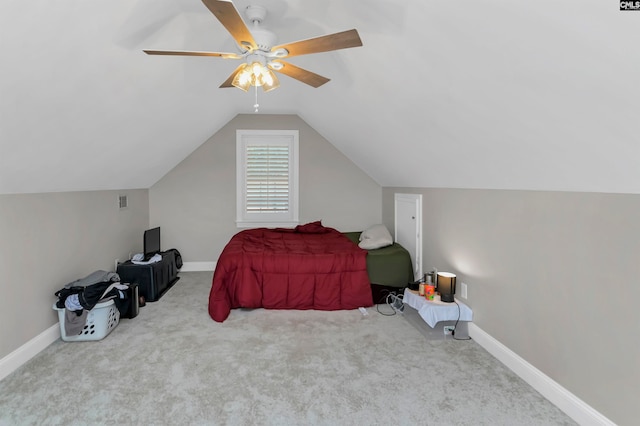 bedroom with vaulted ceiling, ceiling fan, and light colored carpet