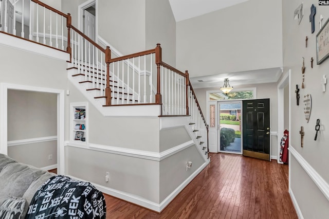 entryway featuring high vaulted ceiling and wood-type flooring