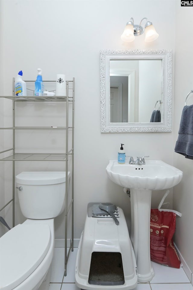 bathroom with toilet and tile patterned floors