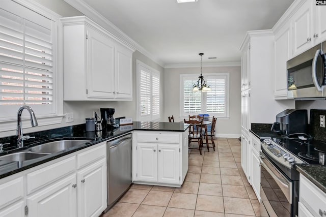 kitchen featuring appliances with stainless steel finishes, sink, and white cabinets